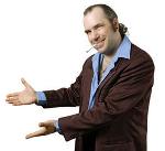 A man dressed in a suit, referred as Shin-Splints - The Wanna-Be, holds his hands out in a welcoming or open gesture